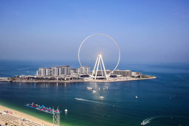 istock Dubai, UAE - 08.15.2020: Bright day view of white the largest ferris observation wheel 1289018541