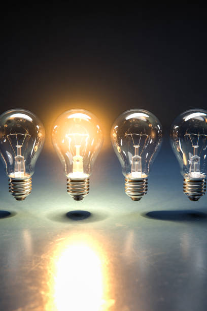 istock A row of lightbulbs with one brigthly lit - concept for having an idea, innovation, standing out. 1289019775