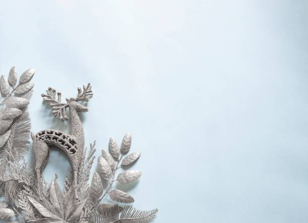 istock christmas background with silver leaves and reindeer ornaments 1289020130