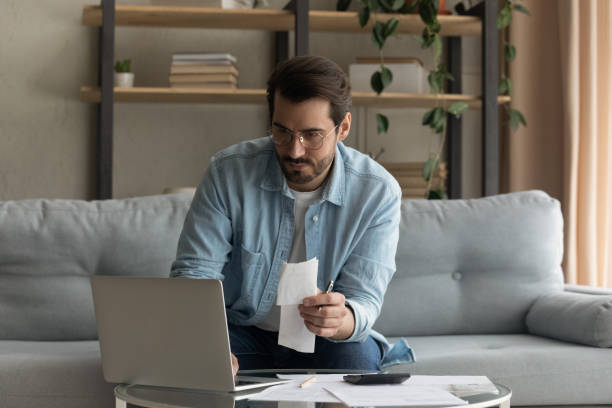 istock Young Caucasian man manage household finances using laptop 1289021385