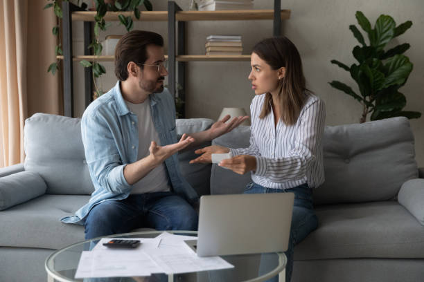 istock Unhappy couple pay bills argue having financial problems 1289021402