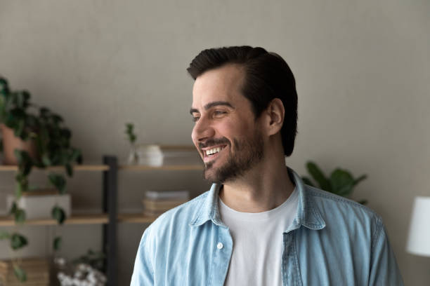 istock Smiling young man look in distance thinking or dreaming 1289021404