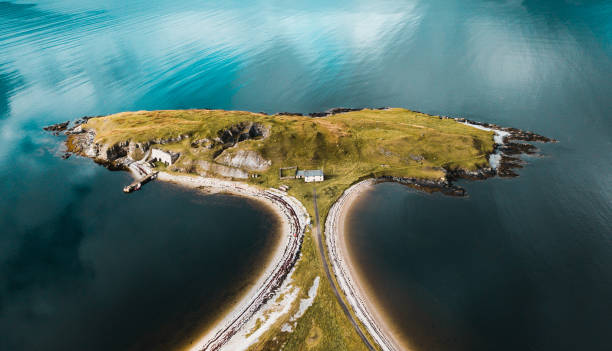 A isolated house on an island in a lake.