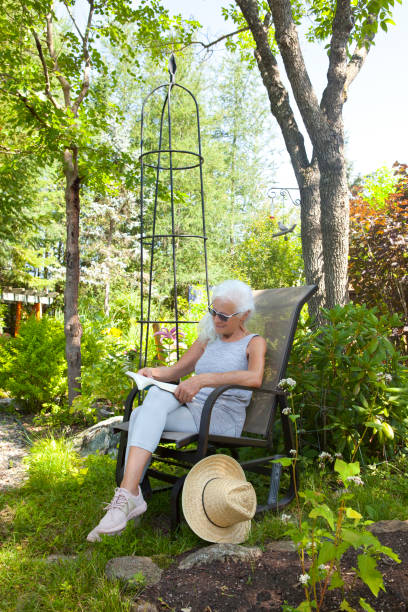 istock Senior Lady Reading Peacefully in her Beauriful Garden 1289025488