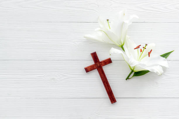 istock Lily funeral flower with cross. Condolence card with copy space 1289025611