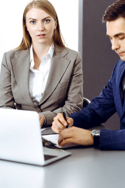 istock Business people using laptop pc while discussing project in office. Successful meeting and negotiation concepts 1289025940