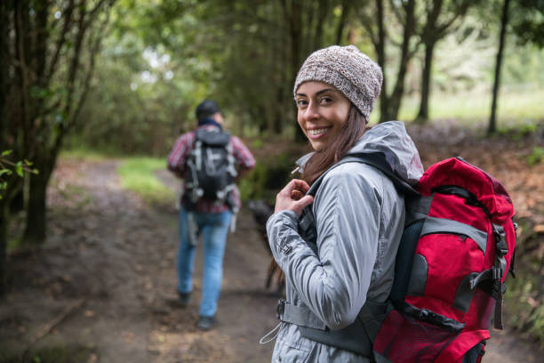 istock Woman having fun hiking and looking at the camera smiling 1289027012