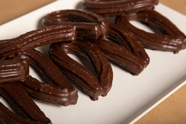 istock Spanish traditional fried-dough pastry churros in chocolate glaze 1289027262