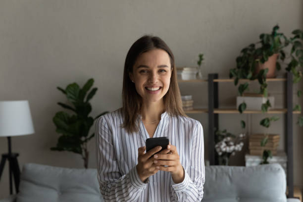 istock Portrait of smiling woman client using smartphone 1289027479