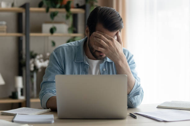 istock Unhappy man feel distressed reading bad email letter 1289027525