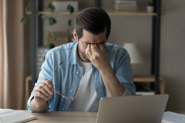 istock Unwell man take off glasses suffer from headache 1289027530