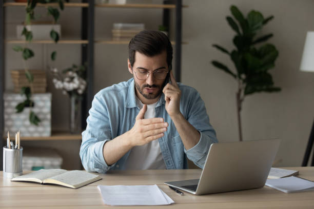 istock Young man have cellphone call at home office 1289027537