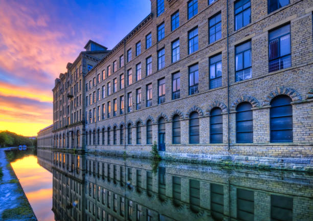 Salt's Mill Unesco world heritage site, Saltaire, West Yorkshire, England, Britain Colorful sunrise at famous Victorian mill on Leeds-Liverpool canal west yorkshire stock pictures, royalty-free photos & images