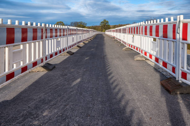 istock Securing a large construction site with a plastic barrier fence 1289028978