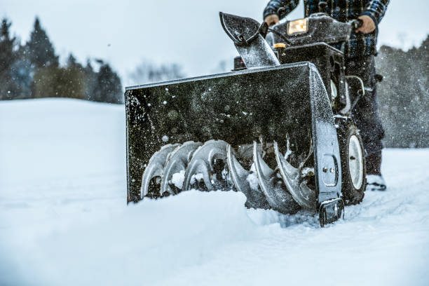 Close-up of tractor tracks on snow-covered cobblestones. Tire tracks on a winter road.