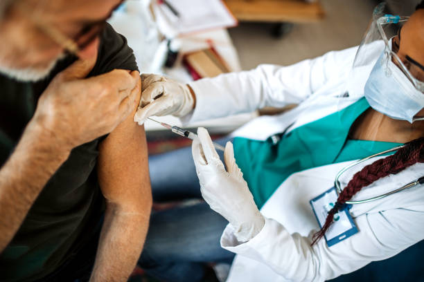 istock Doctor Injecting flu vaccine into patient's arm 1289030579