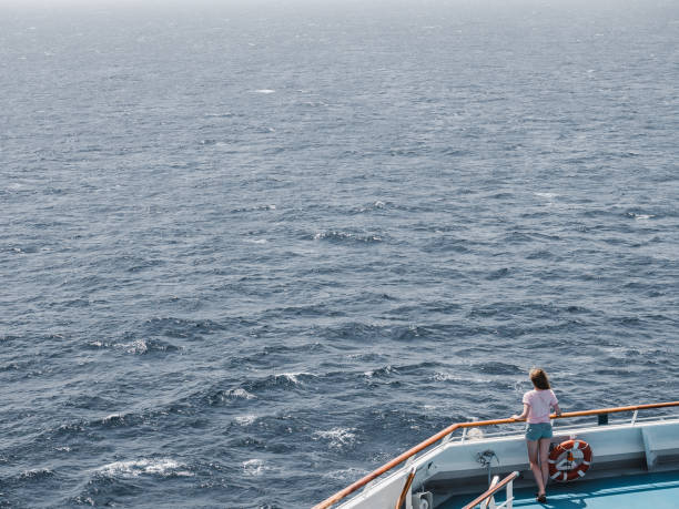istock Woman on the empty deck of a cruise liner 1289031668