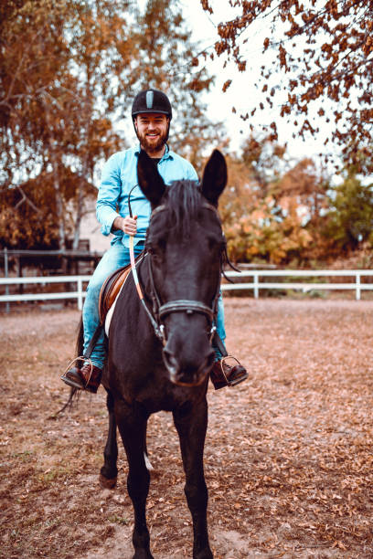 istock Smiling Male Enjoying Horse Riding On Ranch 1289031832