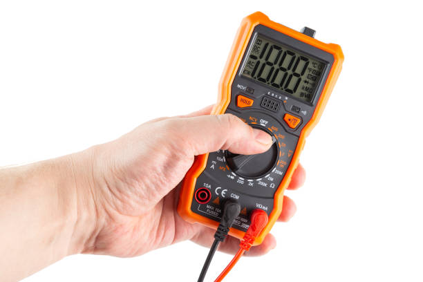 istock lcd screen digital electrical multimeter in left hand, isolated on white background, mockup with all on 1289032031
