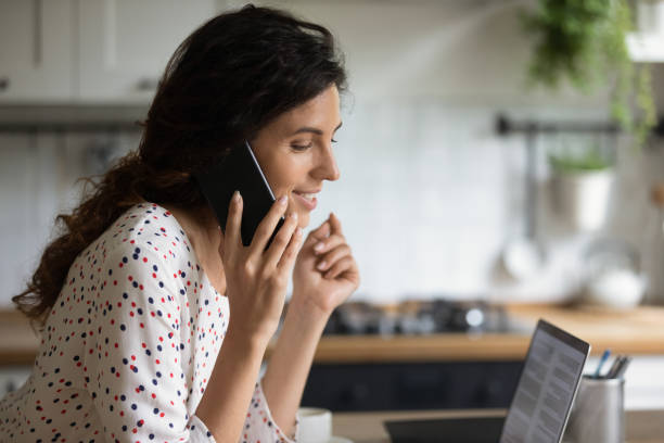 istock Caucasian woman talk on smartphone at home 1289033399