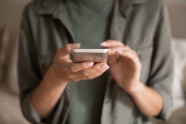 istock Crop of woman using modern smartphone gadget 1289033474