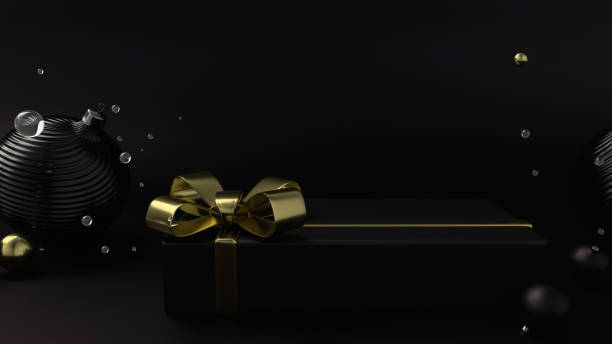 Christmas elegant gift box with a gold ribbon, black flat background. stock photo