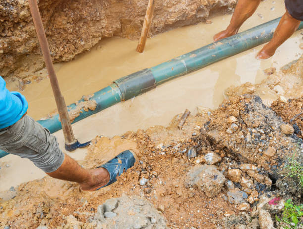 istock plumber dig repair main plumbing  PVC pipe on road 1289035621