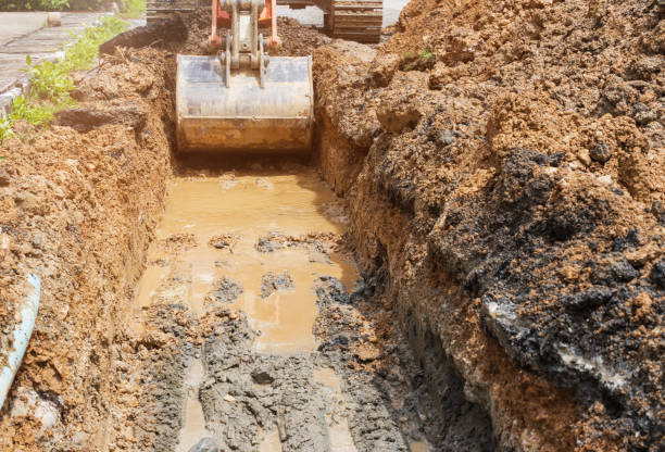 istock backhoe dig repair broken water line pipe main plumbing on road 1289035629
