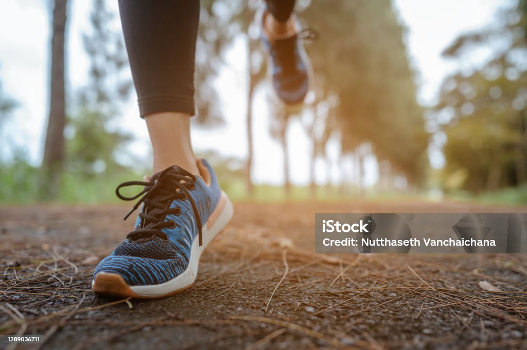 A woman Jogging in the natural park. Legs close up. Racewalking Stock Photo