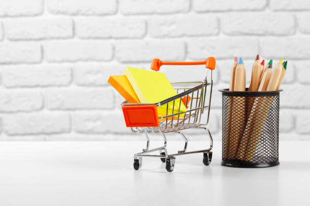 istock Mini shopping cart with multi-colored pens and pencils. creative photo. 1289036805