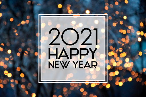 2021 New Year sign on a glowing background. Happy New Year 2021 night defocused lights texture greeting card images