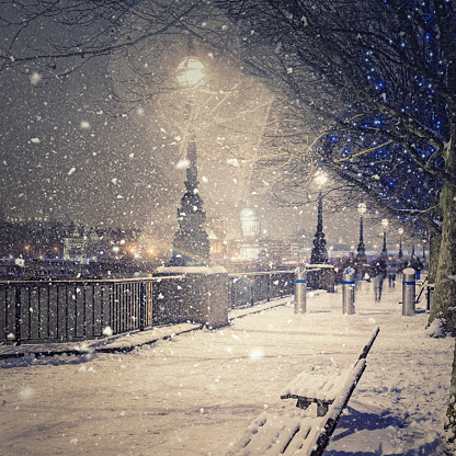 View of St Pauls Cathedral from The Queen's Walk during a snowstorm in London.