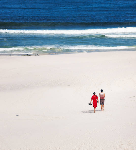 Young couple enjoying a day at a South African white sands beach, in a beautiful remote wild area with no-one else around.