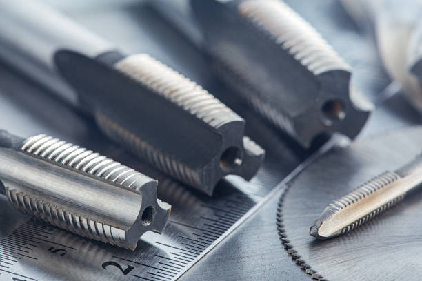 istock set of different drill bits,thread taps and mill cutters with ruler on steel plate background. Locksmithing deal. 1289037806