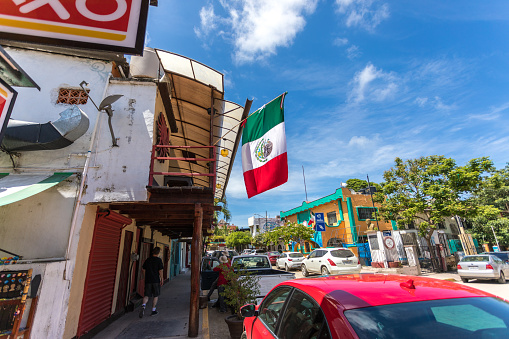 Sayulita, Mexico - September, 2018: Mexican flag hangs proudly off local convenience store in small colorful town of Sayulita.