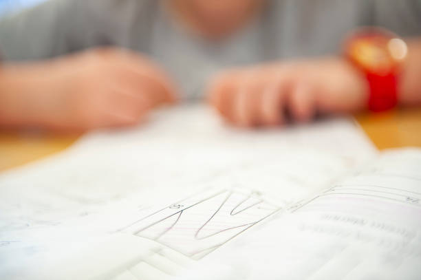 istock Student sitting at desk in school and drawing blueprint 1289038759