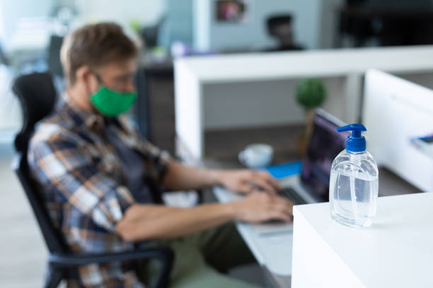 istock Caucasian man wearing face mask in an office 1289040445