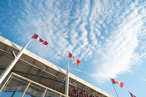 The flag of Canada under the blue sky