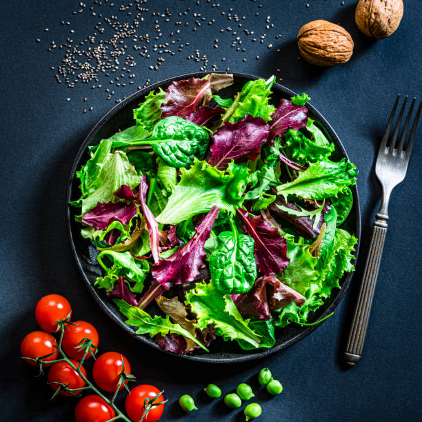 istock Fresh lettuce salad plate on dark background. Copy space 1289043810