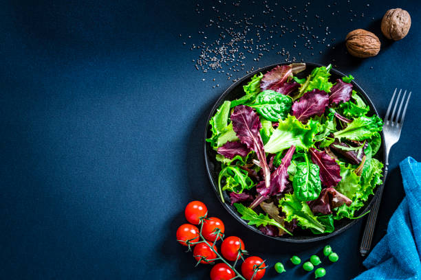 istock Fresh lettuce salad plate on dark background. Copy space 1289043900