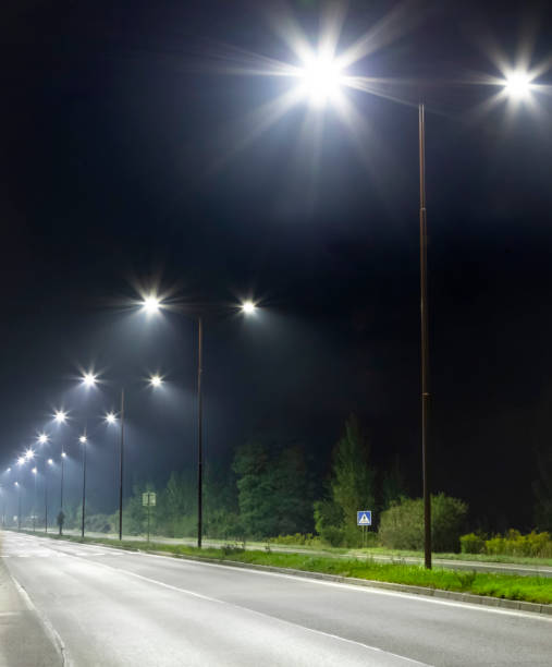 istock night empty road with bright LED streetlights, modern illumination 1289045777