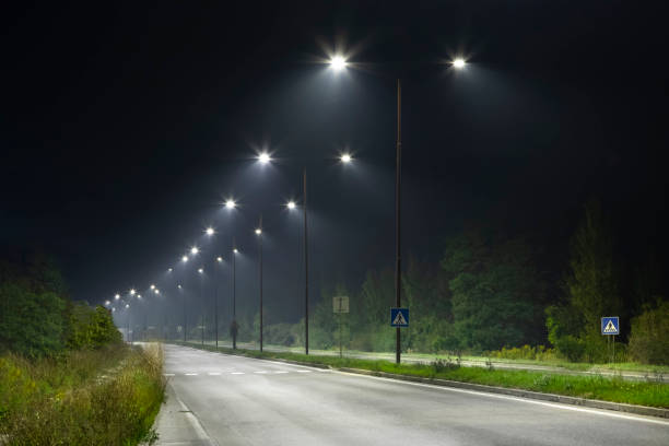 istock night empty road with bright LED streetlights, modern illumination 1289045877