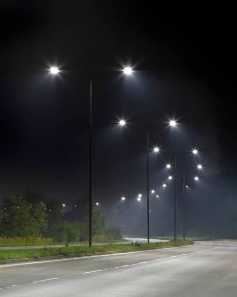 istock night empty road with bright LED streetlights, modern illumination 1289045944