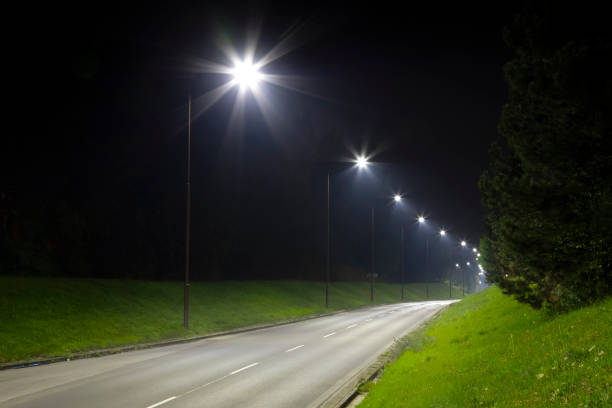 istock night empty road with bright LED streetlights, modern illumination 1289045972