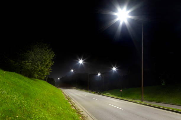 istock night empty road with bright LED streetlights, modern illumination 1289046080