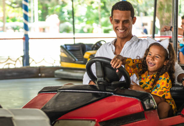 istock Father and daughter enjoying bumper car ride 1289047089