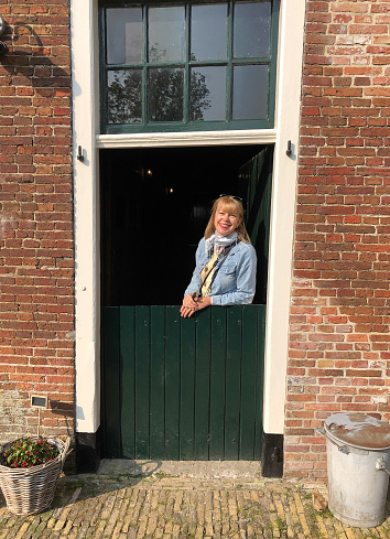 Friesland, Netherlands: Blond Woman at Dutch Door