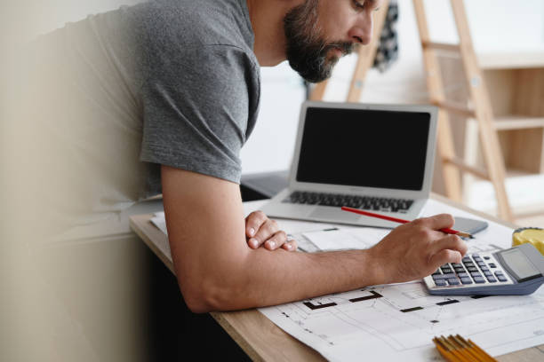 istock Side view man using a calculator to calculate the usable area 1289047417