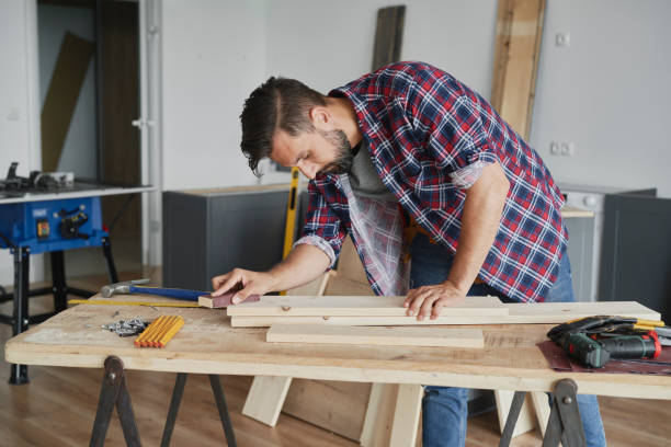 istock Carpenter cleaning the boards with sandpaper 1289048188