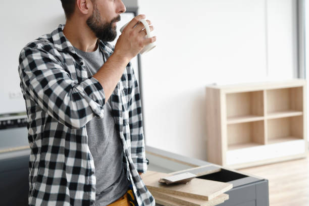 istock Unrecognizable man drinking cup of coffee during breaks in work 1289048294